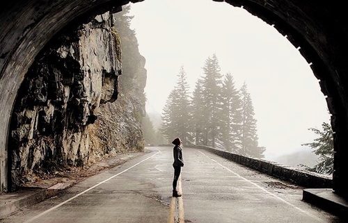 Woman in tunnel looking at light