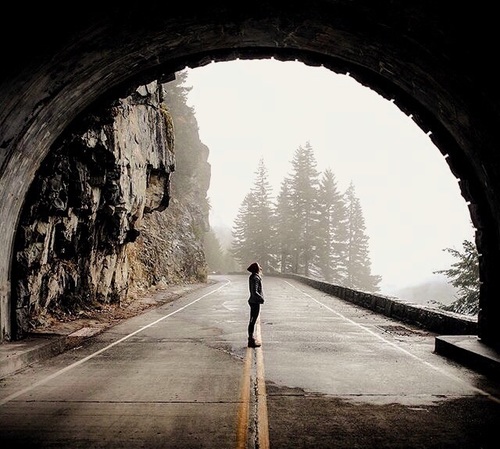 Woman in tunnel looking at light