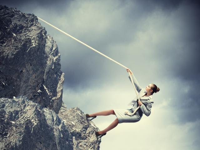 Woman climbing rocks as metaphor of seeking divorce support