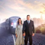 Sarah Jessica Parker and Thomas Haden Church walking on railroad tracks with train coming