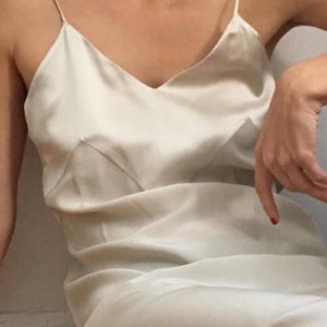 Woman in satin slip with no rings