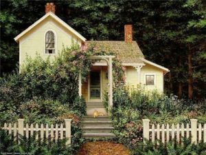 Yellow house with picket fence, cat and roses on vines