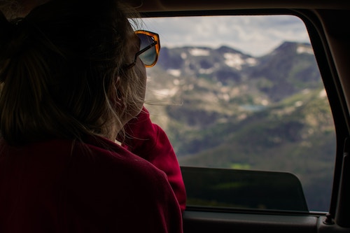 A woman looking out at a window thinking about her unwanted divorce