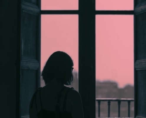 A woman starting out the window thinking of divorce facts