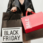 A woman holding multiple Black Friday and sale shopping bags, symbolizing emotional spending and the financial temptations many women face during and after divorce.