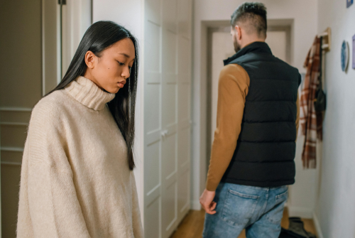 Dissolution of a marriage by pexels Woman in cream sweater behind a man in black vest heading out door