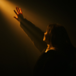 Woman reaching toward light, representing healing after divorce for women and the hope of a new beginning