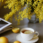 Cup of lemon tea beside fresh flowers, symbolizing comfort, healing, and new beginnings after divorce