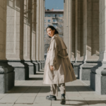 Woman walking alone between stone columns, symbolizing independence and reflection after divorce