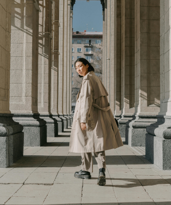 Woman walking alone between stone columns, symbolizing independence and reflection after divorce
