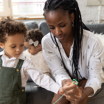 Mother helping her children with an activity at home, representing everyday coparenting coordination