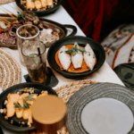 A celebratory dinner table with cocktails, champagne, and shared dishes, symbolizing women celebrating freedom and new beginnings after divorce.