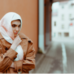 Woman looking concerned while standing alone outdoors, representing harassment by ex-husband after divorce